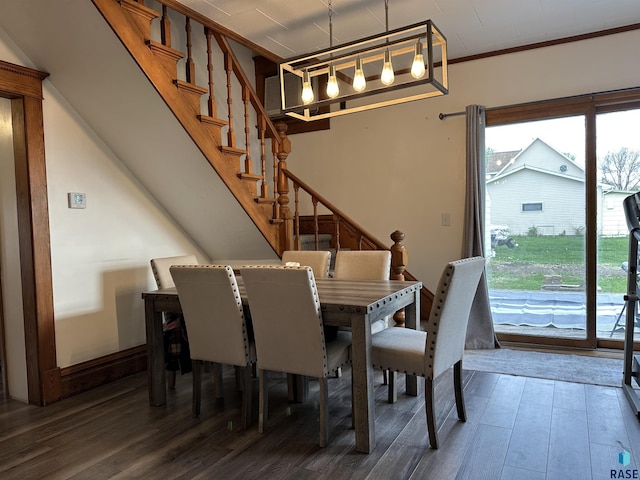 531 N Adams St, Salem, SD 57058 - dining room featuring wood finished floors, stairway, and ornamental molding