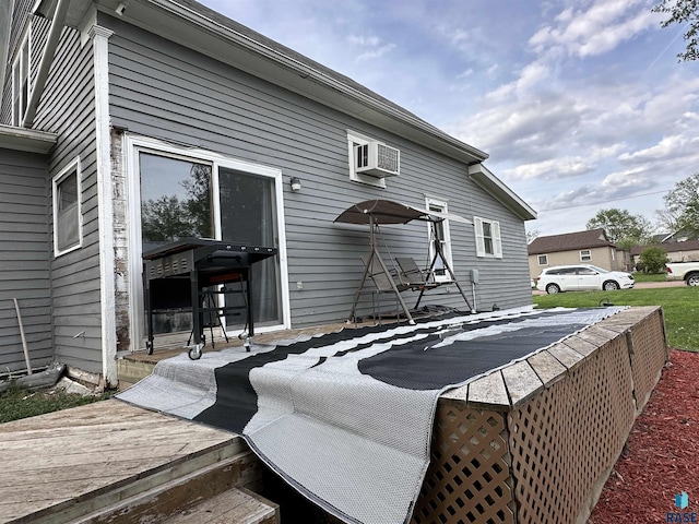 531 N Adams St, Salem, SD 57058 - rear view of property with an AC wall unit and a wooden deck