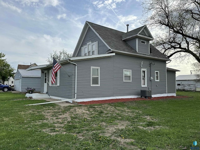 531 N Adams St, Salem, SD 57058 - back of house featuring central AC unit and a lawn