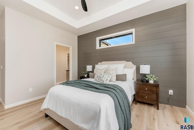 bedroom with wood walls, light wood-style floors, baseboards, recessed lighting, and ceiling fan