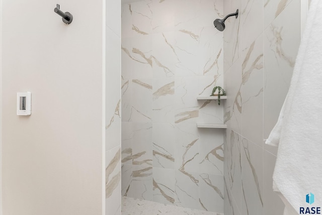 full bath featuring a marble finish shower