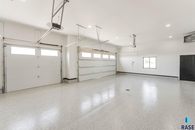 garage featuring baseboards, a garage door opener, and recessed lighting