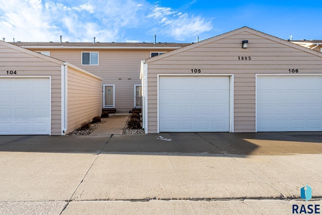 1805 S Sertoma Ave Unit 105, Sioux Falls, SD 57106 - view of front of house featuring community garages and an outbuilding