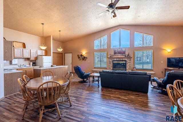 1805 S Sertoma Ave Unit 105, Sioux Falls, SD 57106 - dining space with dark wood finished floors, ceiling fan, healthy amount of natural light, a textured ceiling, and high vaulted ceiling