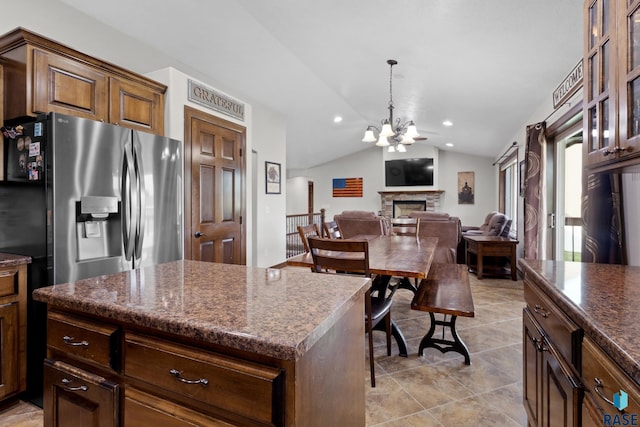 2300 Carson Cir, Tea, SD 57064 - kitchen with stainless steel refrigerator with ice dispenser, lofted ceiling, a chandelier, a fireplace, and a center island