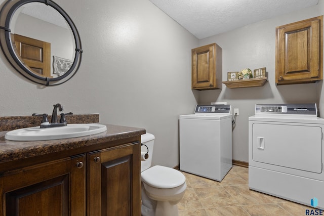 2300 Carson Cir, Tea, SD 57064 - bathroom with separate washer and dryer, toilet, a textured ceiling, and vanity