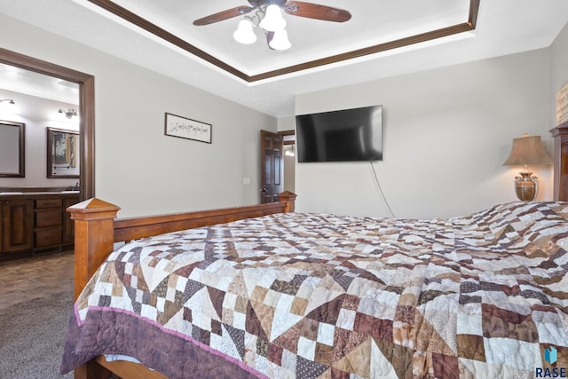 2300 Carson Cir, Tea, SD 57064 - bedroom featuring a tray ceiling, connected bathroom, and ceiling fan