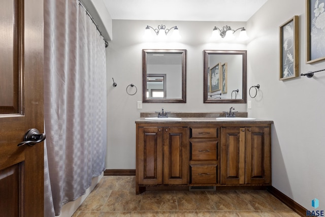 2300 Carson Cir, Tea, SD 57064 - bathroom featuring baseboards, double vanity, and curtained shower