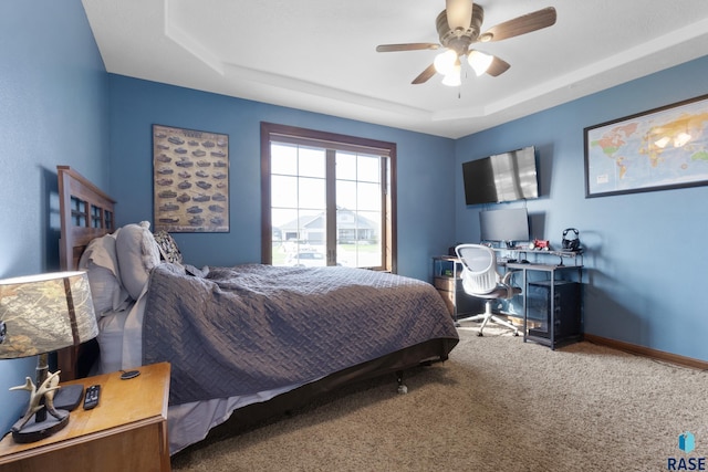2300 Carson Cir, Tea, SD 57064 - carpeted bedroom with a raised ceiling, an office area, baseboards, and a ceiling fan