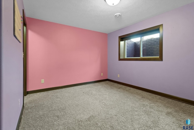 2300 Carson Cir, Tea, SD 57064 - carpeted empty room featuring baseboards and a textured ceiling