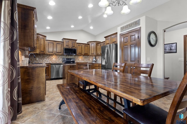 2300 Carson Cir, Tea, SD 57064 - dining room with lofted ceiling, arched walkways, a chandelier, light tile patterned floors, and recessed lighting