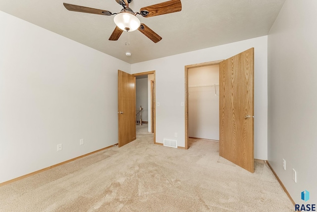 2604 N Wright Ave, Sioux Falls, SD 57107 - unfurnished bedroom featuring light colored carpet, baseboards, a closet, and a ceiling fan