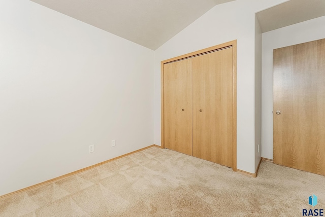 2604 N Wright Ave, Sioux Falls, SD 57107 - unfurnished bedroom with vaulted ceiling, carpet floors, a closet, and baseboards