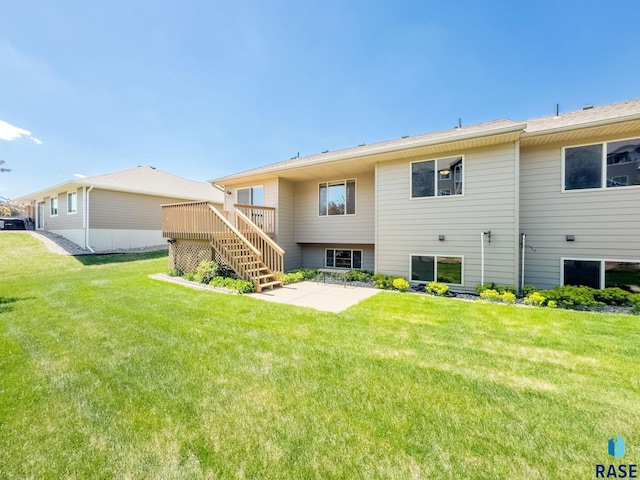 2604 N Wright Ave, Sioux Falls, SD 57107 - back of house with stairway, a patio, a wooden deck, and a lawn