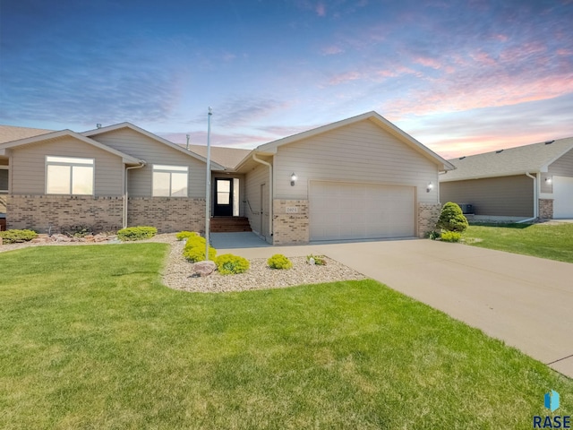 2604 N Wright Ave, Sioux Falls, SD 57107 - ranch-style house with brick siding, an attached garage, driveway, and a front yard