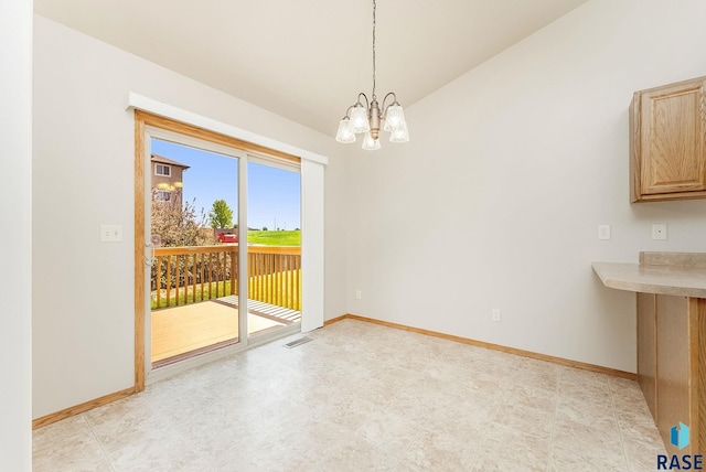 2604 N Wright Ave, Sioux Falls, SD 57107 - unfurnished dining area featuring a chandelier, lofted ceiling, and baseboards