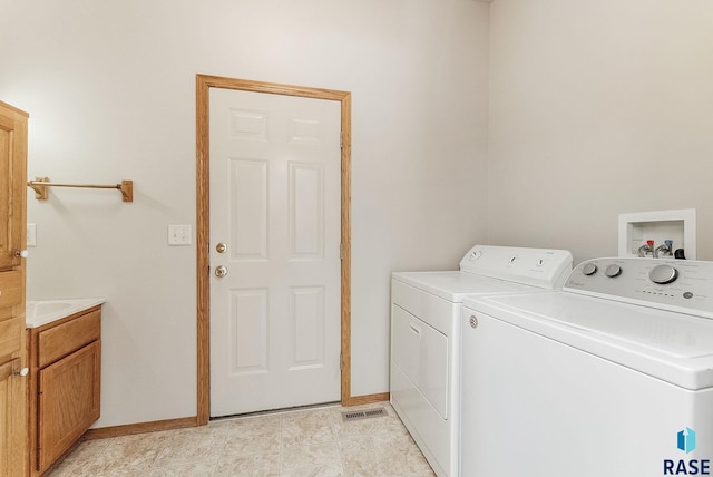 2604 N Wright Ave, Sioux Falls, SD 57107 - laundry room with cabinet space, separate washer and dryer, and baseboards