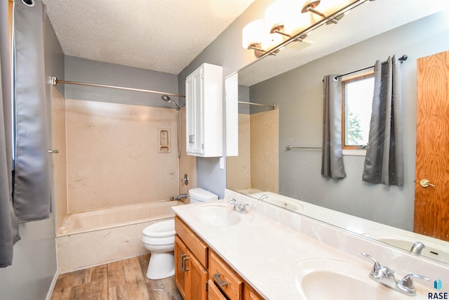 4600 S Harrington Ave, Sioux Falls, SD 57103 - full bathroom featuring toilet, wood finished floors, bathing tub / shower combination, a textured ceiling, and double vanity