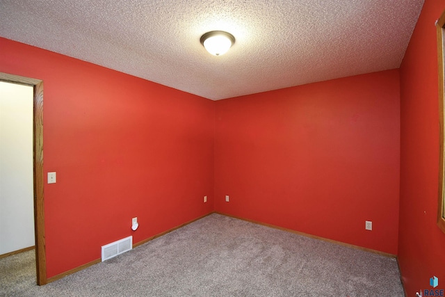 4600 S Harrington Ave, Sioux Falls, SD 57103 - unfurnished room featuring carpet floors, a textured ceiling, and baseboards