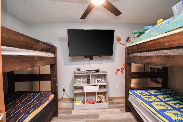 4600 S Harrington Ave, Sioux Falls, SD 57103 - bedroom featuring wood finished floors, a textured ceiling, baseboards, and ceiling fan