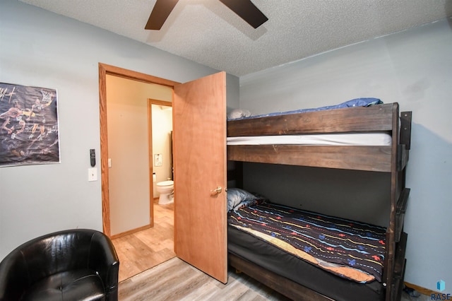 4600 S Harrington Ave, Sioux Falls, SD 57103 - bedroom featuring wood finished floors, a textured ceiling, and a ceiling fan