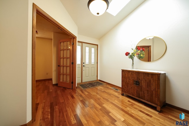 5223 E Pop Fly Pl, Sioux Falls, SD 57110 - foyer featuring wood finished floors, lofted ceiling, baseboards, and a skylight