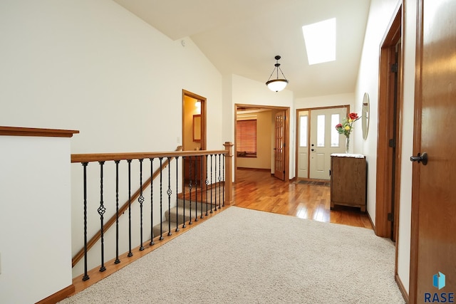 5223 E Pop Fly Pl, Sioux Falls, SD 57110 - corridor featuring a skylight, lofted ceiling, an upstairs landing, wood finished floors, and carpet flooring