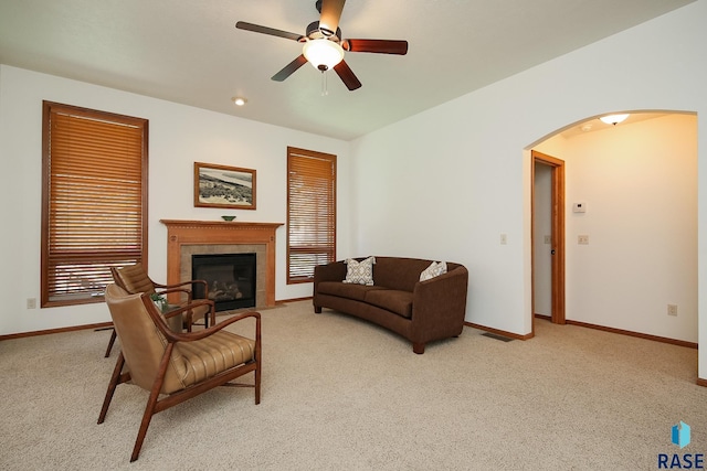 5223 E Pop Fly Pl, Sioux Falls, SD 57110 - living room featuring arched walkways, ceiling fan, light colored carpet, and baseboards