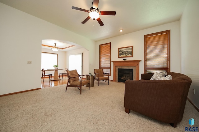 5223 E Pop Fly Pl, Sioux Falls, SD 57110 - living area featuring light colored carpet, arched walkways, baseboards, and ceiling fan