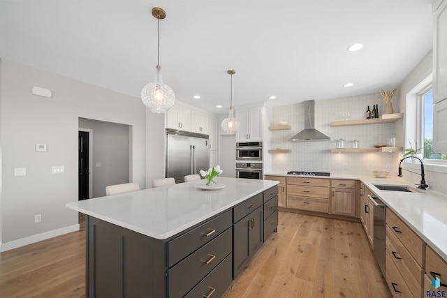 2009 S Firestone Ln, Sioux Falls, SD 57110 - kitchen featuring wall chimney exhaust hood, stainless steel appliances, a sink, open shelves, and light wood-style flooring