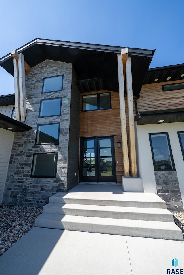 2009 S Firestone Ln, Sioux Falls, SD 57110 - view of exterior entry featuring french doors and stone siding