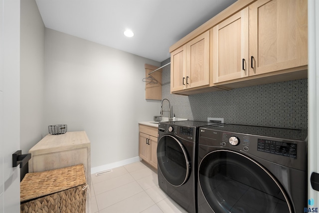 2009 S Firestone Ln, Sioux Falls, SD 57110 - clothes washing area featuring washing machine and clothes dryer, cabinet space, light tile patterned floors, baseboards, and recessed lighting