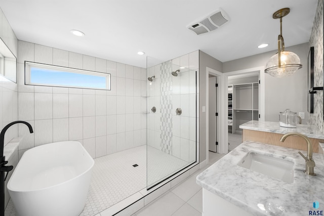 2009 S Firestone Ln, Sioux Falls, SD 57110 - full bathroom featuring tiled shower, a soaking tub, vanity, a walk in closet, and recessed lighting