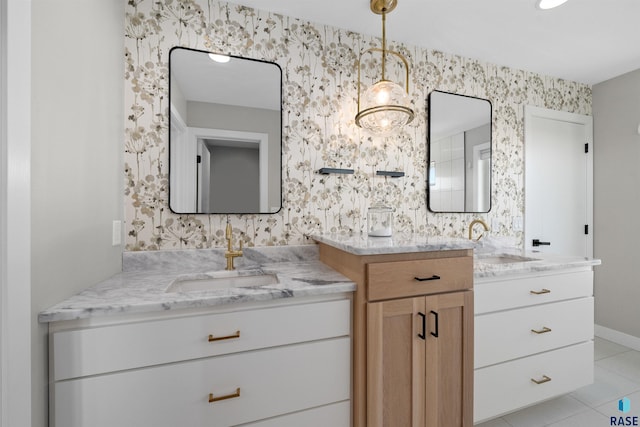 2009 S Firestone Ln, Sioux Falls, SD 57110 - bathroom with wallpapered walls, two vanities, tile patterned flooring, and baseboards