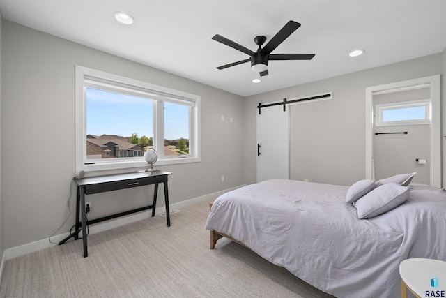 2009 S Firestone Ln, Sioux Falls, SD 57110 - bedroom featuring a barn door, recessed lighting, baseboards, light colored carpet, and ceiling fan