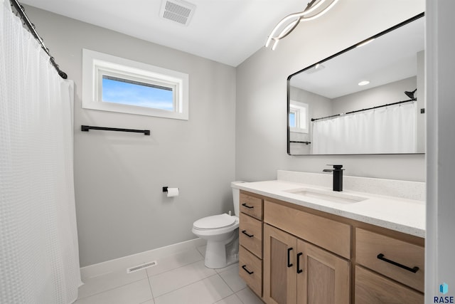 2009 S Firestone Ln, Sioux Falls, SD 57110 - full bath featuring plenty of natural light, baseboards, tile patterned floors, and toilet
