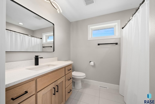 2009 S Firestone Ln, Sioux Falls, SD 57110 - full bathroom featuring plenty of natural light, baseboards, tile patterned flooring, and vanity