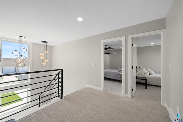 2009 S Firestone Ln, Sioux Falls, SD 57110 - hallway featuring an upstairs landing, carpet flooring, recessed lighting, a chandelier, and baseboards