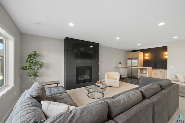 2009 S Firestone Ln, Sioux Falls, SD 57110 - living area with light wood-style floors, recessed lighting, a fireplace, and healthy amount of natural light