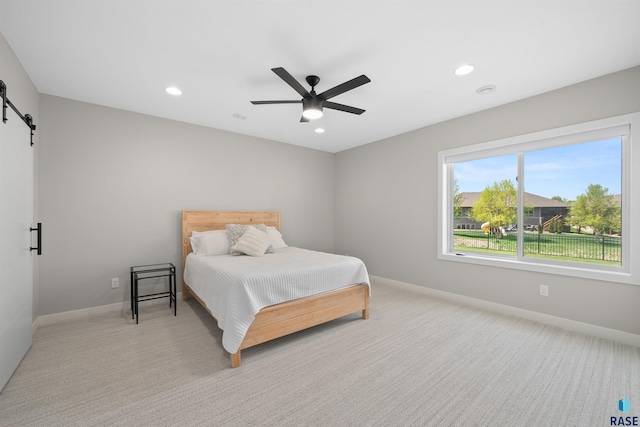2009 S Firestone Ln, Sioux Falls, SD 57110 - bedroom featuring a barn door, light colored carpet, baseboards, recessed lighting, and a ceiling fan