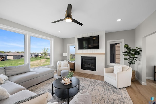 2009 S Firestone Ln, Sioux Falls, SD 57110 - living room featuring baseboards, plenty of natural light, a glass covered fireplace, light wood-type flooring, and recessed lighting