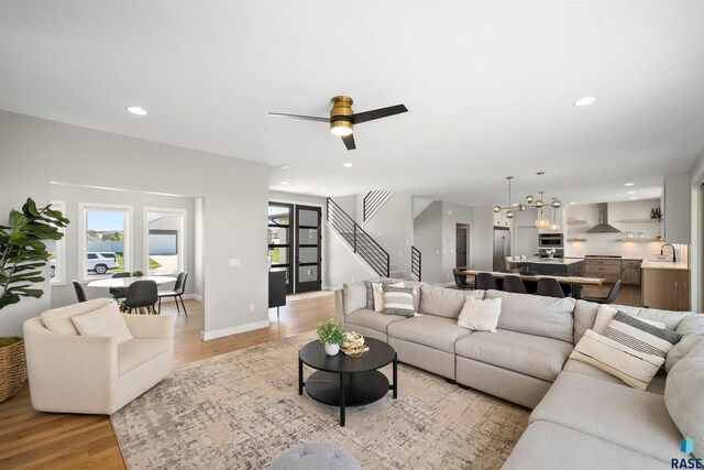 2009 S Firestone Ln, Sioux Falls, SD 57110 - living room featuring light wood-style flooring, stairs, recessed lighting, and ceiling fan