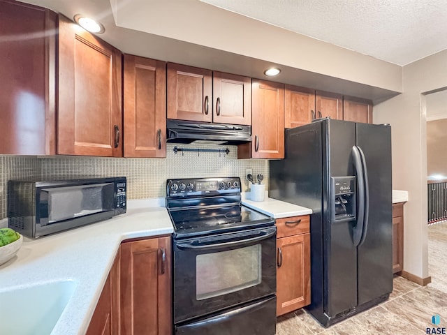 120 S Yellowstone Dr, Brandon, SD 57005 - kitchen with black appliances, under cabinet range hood, light countertops, brown cabinetry, and a textured ceiling