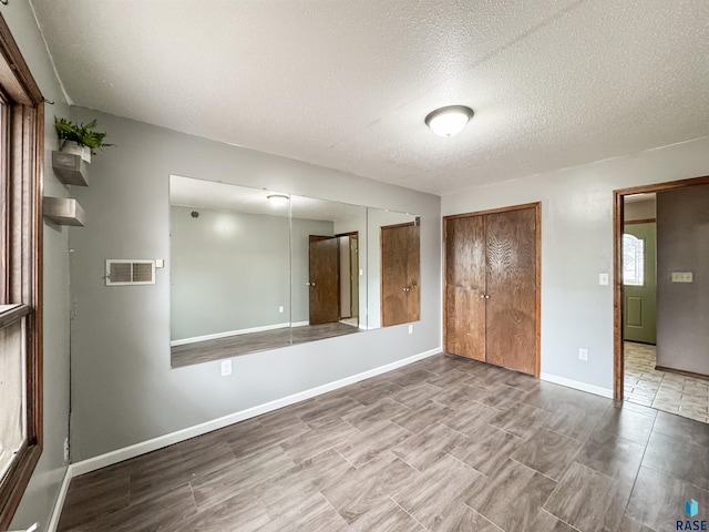 120 S Yellowstone Dr, Brandon, SD 57005 - unfurnished bedroom featuring a closet, a textured ceiling, and baseboards