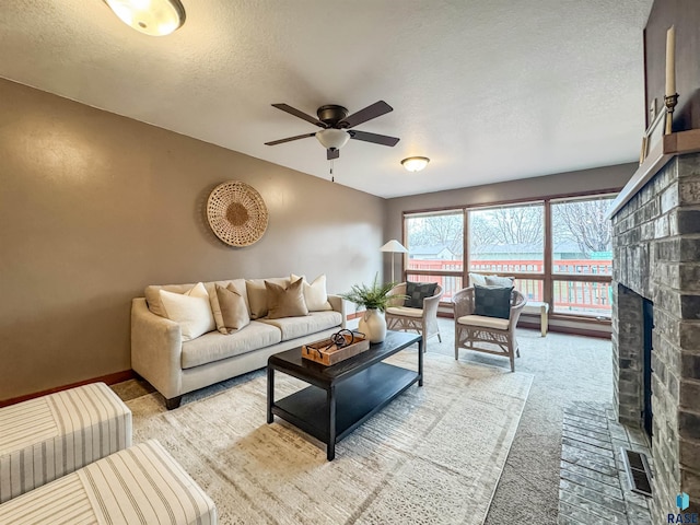 120 S Yellowstone Dr, Brandon, SD 57005 - living area featuring ceiling fan, a textured ceiling, carpet, and a brick fireplace