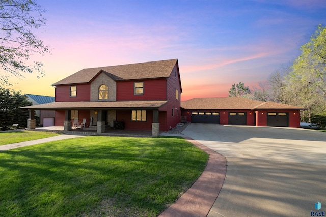 48190 265th St, Brandon, SD 57005 - view of front of house featuring covered porch, driveway, a yard, a garage, and roof with shingles
