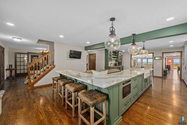 48190 265th St, Brandon, SD 57005 - kitchen with green cabinetry, a sink, dark wood-style floors, a spacious island, and recessed lighting