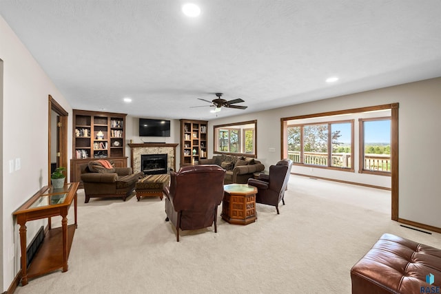 48190 265th St, Brandon, SD 57005 - living room featuring light carpet, a glass covered fireplace, recessed lighting, ceiling fan, and a textured ceiling