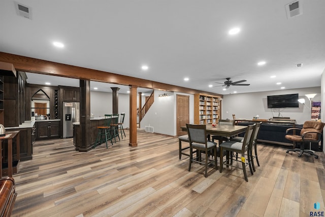 48190 265th St, Brandon, SD 57005 - dining space featuring a dry bar, light wood-type flooring, a ceiling fan, recessed lighting, and stairway
