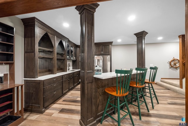 48190 265th St, Brandon, SD 57005 - bar featuring ornate columns, stainless steel fridge, a sink, light wood-type flooring, and recessed lighting